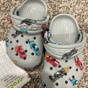 CROCS Kids Classic Clogs in Light Gray with Multicolor Race Car Print